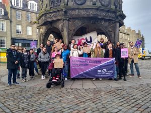 Student activists stand at Castlegate calling for mental health funding.